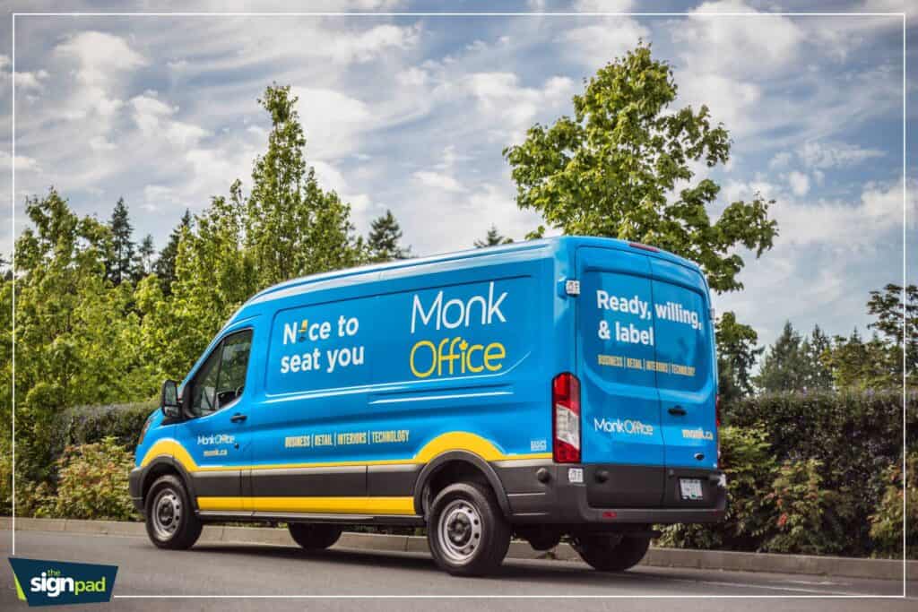 Custom blue vehicle wrap with signage for Monk Office in Victoria.