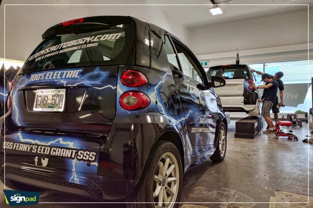 Vehicle wrap with lightning graphics and business branding.