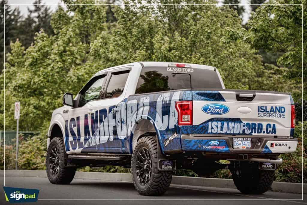 Custom vehicle wrap on Ford truck promoting Island Ford Victoria dealership.