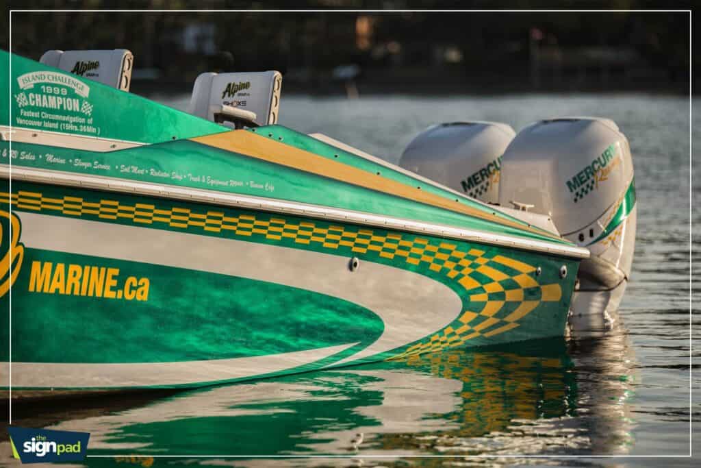 Boat with Mercury outboard motors and custom signage on the water.