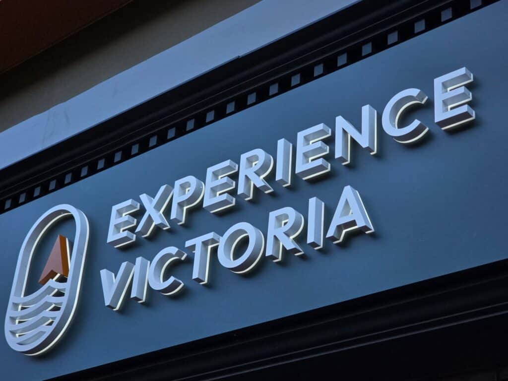 Custom sign reading "Experience Victoria" with logo, for business branding.