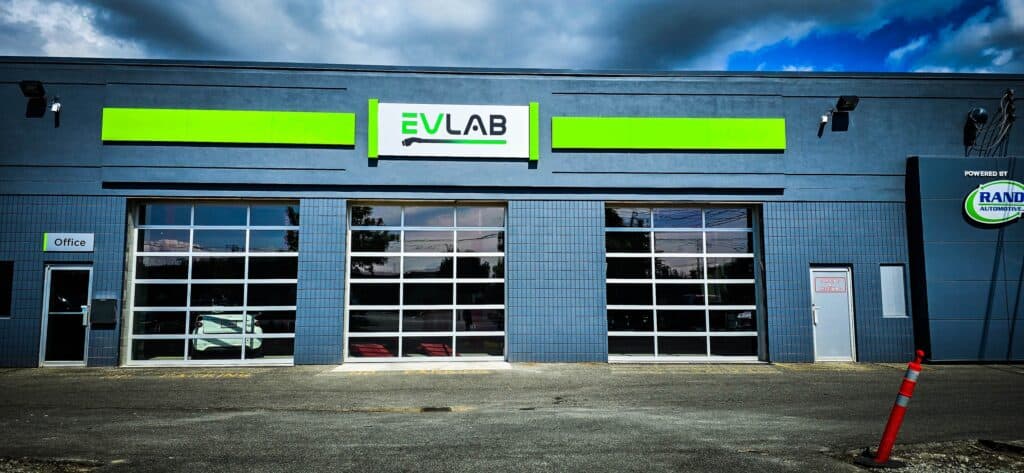 EVULAB sign on commercial building facade with garage doors and branding.