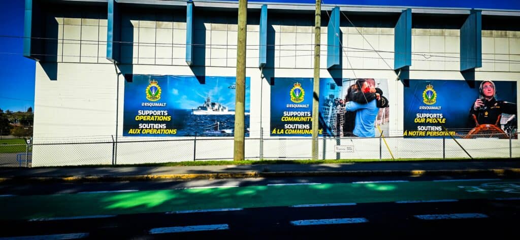 Community support banners on a fence in Victoria, promoting local initiatives.
