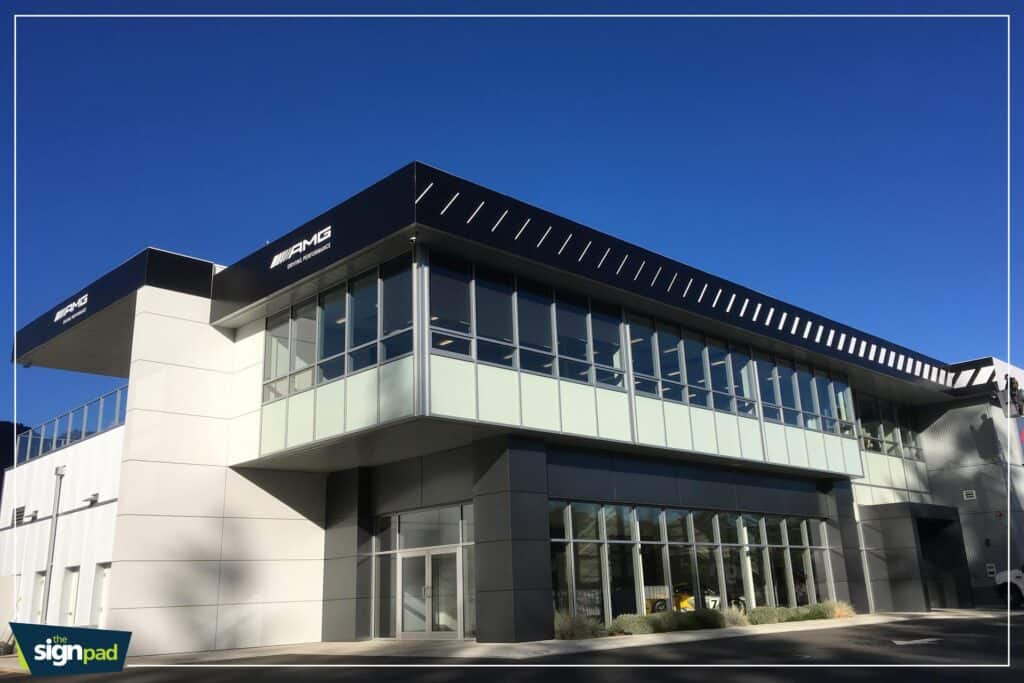 Mercedes-Benz dealership building with large glass windows and modern architecture.