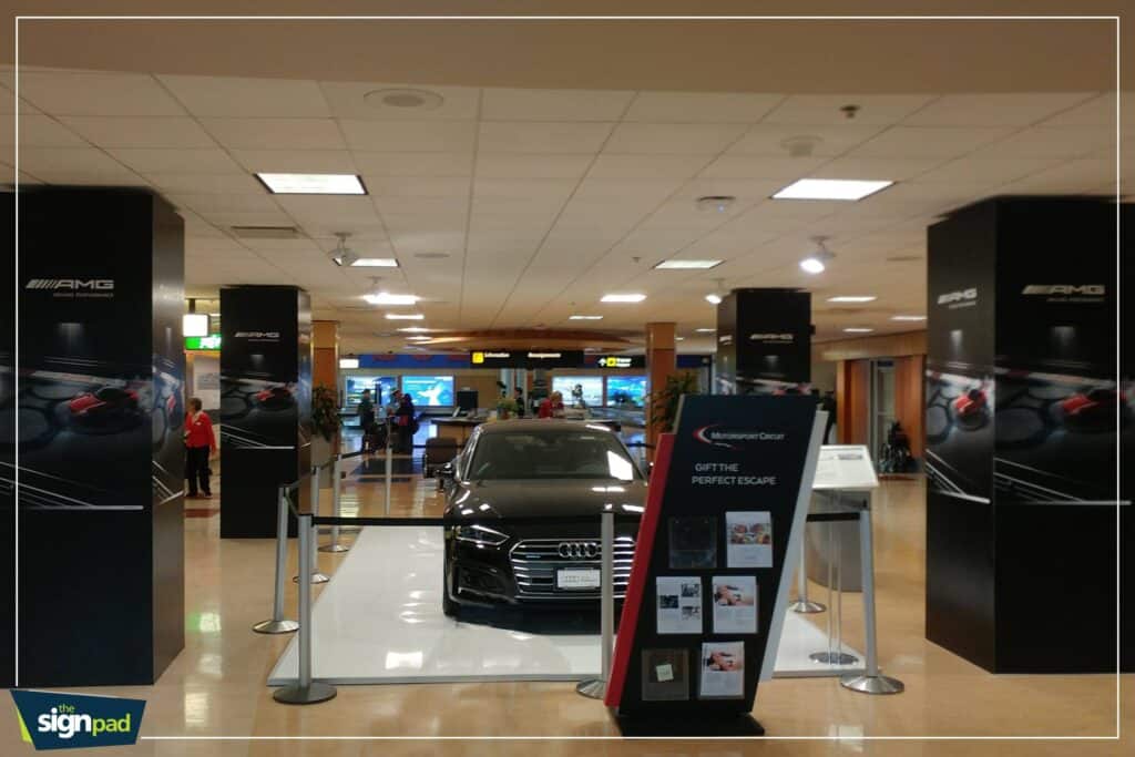 Showroom with luxury car and custom signage at Victoria Mall.