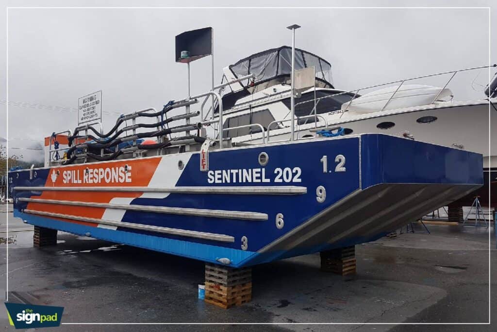 Spill Response Boat with safety and warning signage for maritime safety.