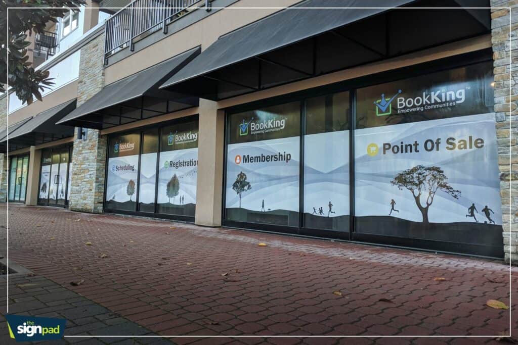 Custom window signs for BookKing promoting membership, point of sale, and scheduling services.