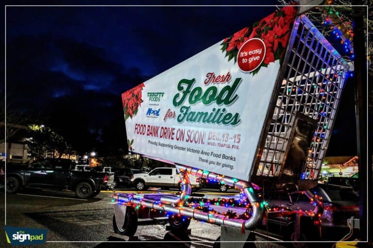 Mobile food bank truck decorated with colorful lights for a community food drive event.