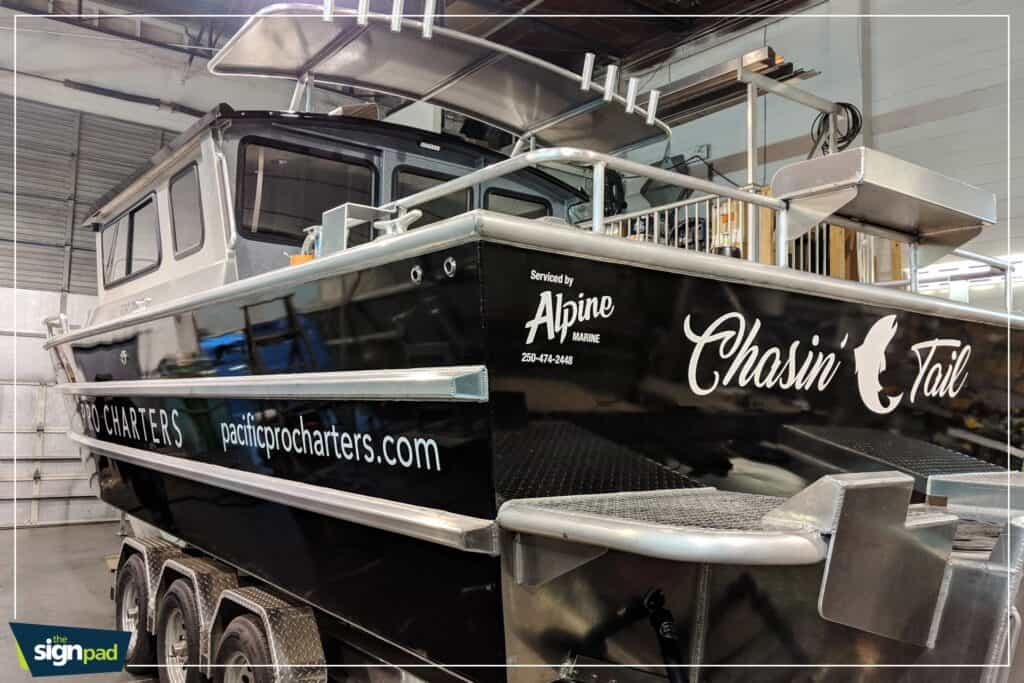 Boat with custom signage and branding in an indoor storage facility.