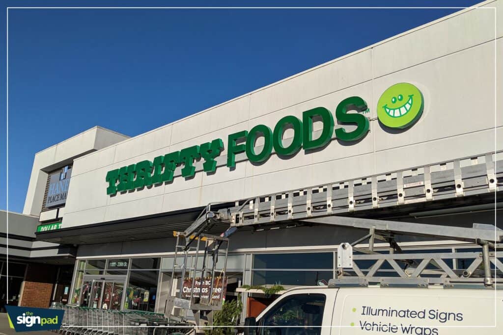 Custom green sign for Terry's Foods store with a smiley face logo.