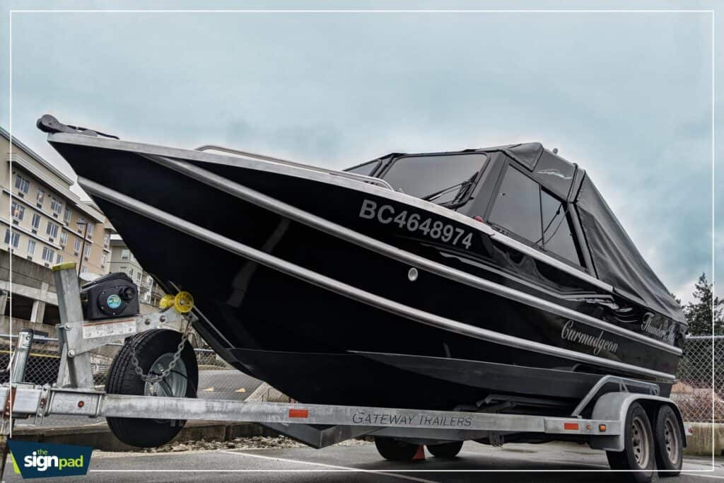 Boat on trailer with registration BC4648974 at marina.