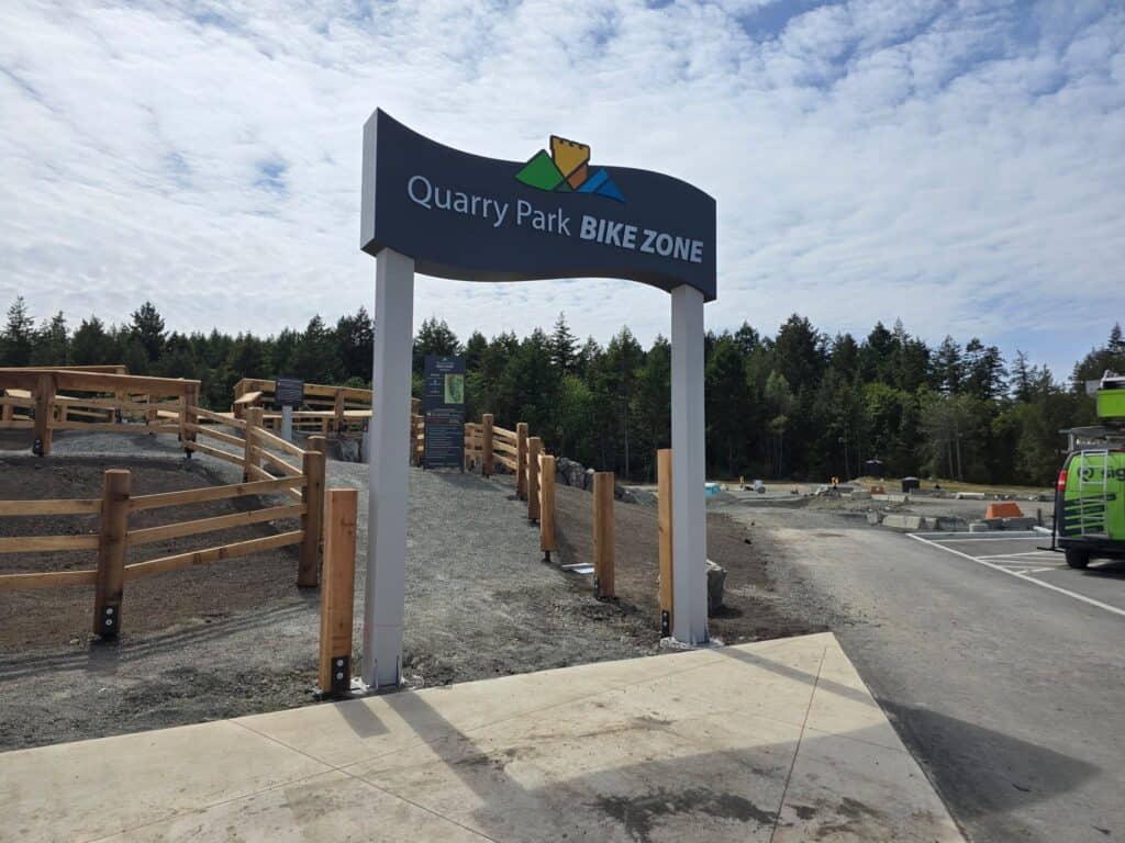 Quarry Park Bike Zone sign at the entrance of the bike trail area.