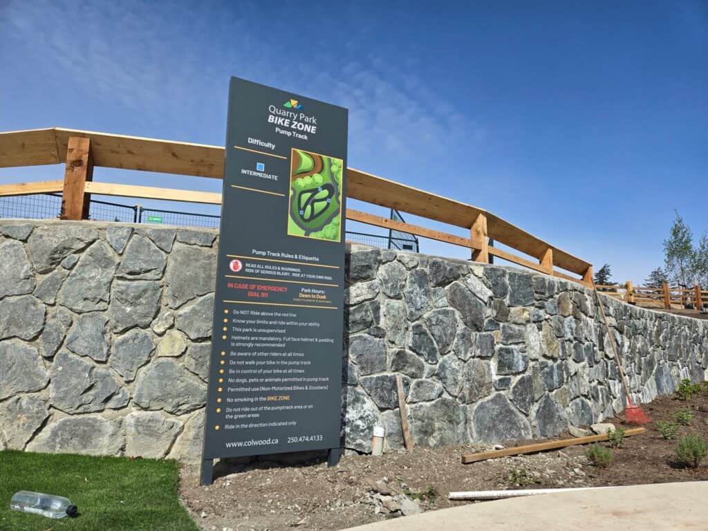 Tall outdoor sign for bike zone at Quenette Park in Victoria.