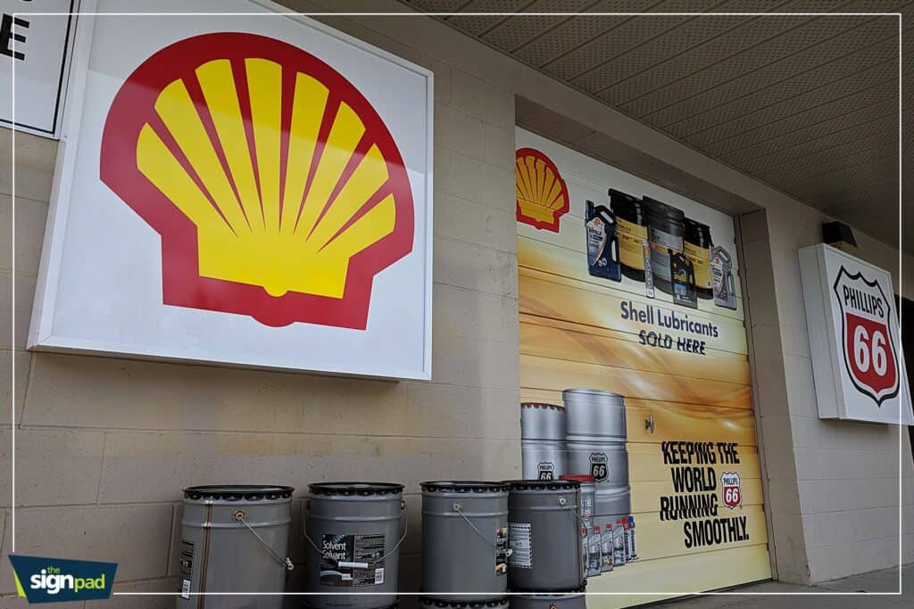 Custom Shell Lubricants sign with logo and product display at Victoria auto shop.