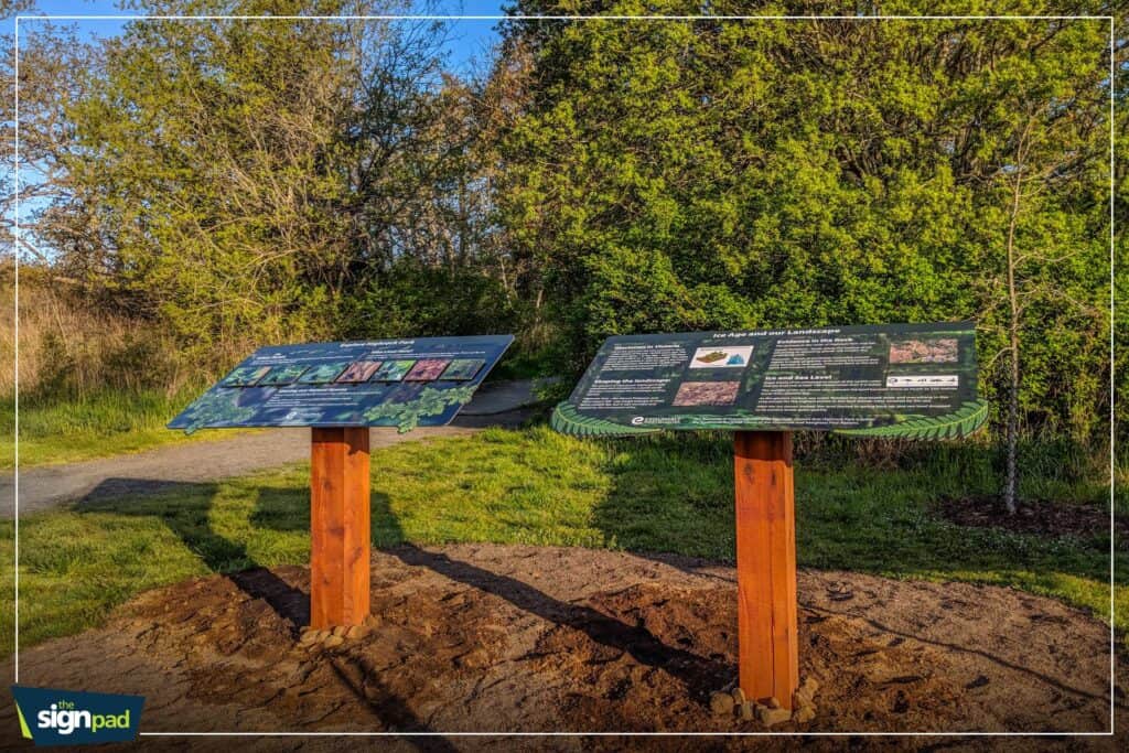 Outdoor informational sign boards with detailed graphics and text.