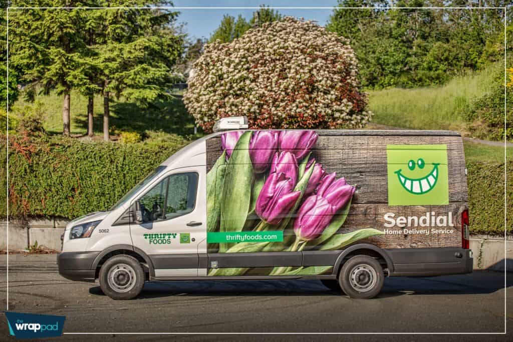 Vehicle wrap featuring vibrant pink tulips and green leaves for Thrifty Foods.