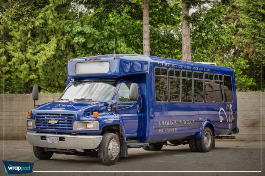Blue shuttle bus with custom signage and branding.