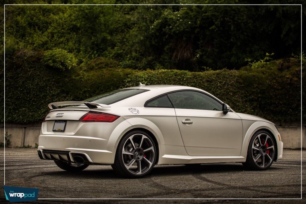 Silver Audi coupe parked outdoors with sleek design and sporty features.