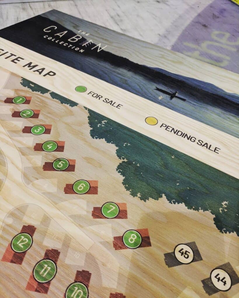 Detailed cabin site map showing sale and pending sale locations with numbered plots.