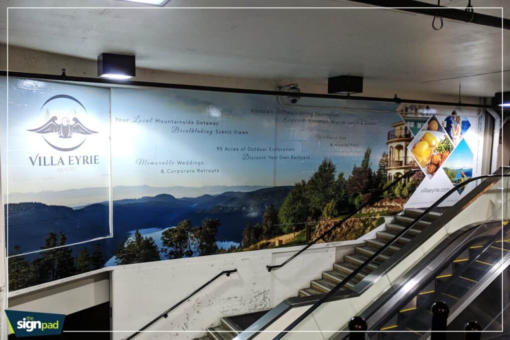 Custom outdoor sign for Villa Eyrie with scenic mountain view backdrop.