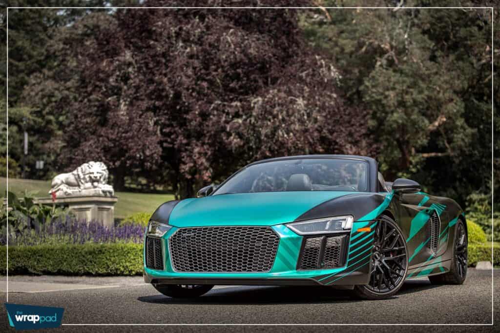 Luxury Audi R8 sports car in vibrant teal color.
