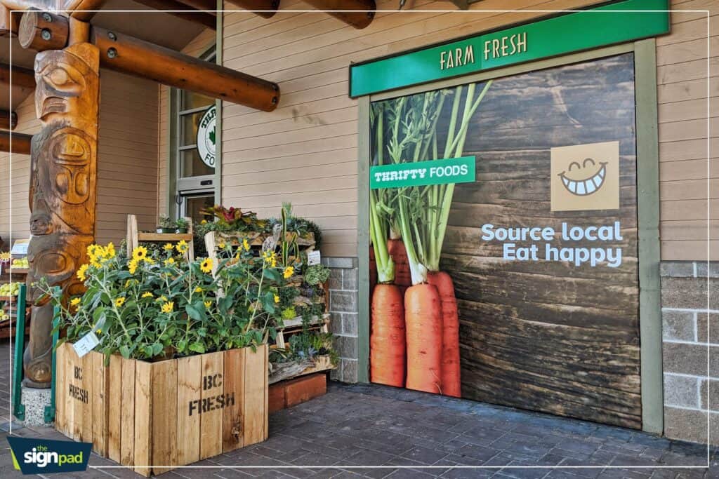 Custom farm fresh produce sign with vegetables and cheerful logo.