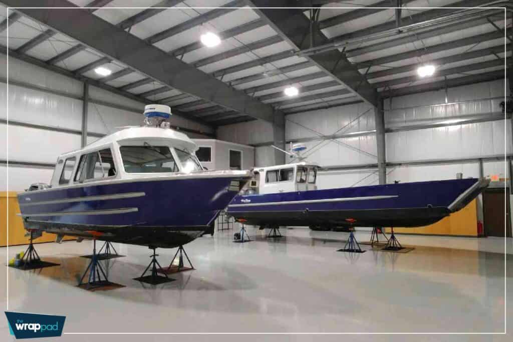 Boat storage with two vessels inside a spacious warehouse.