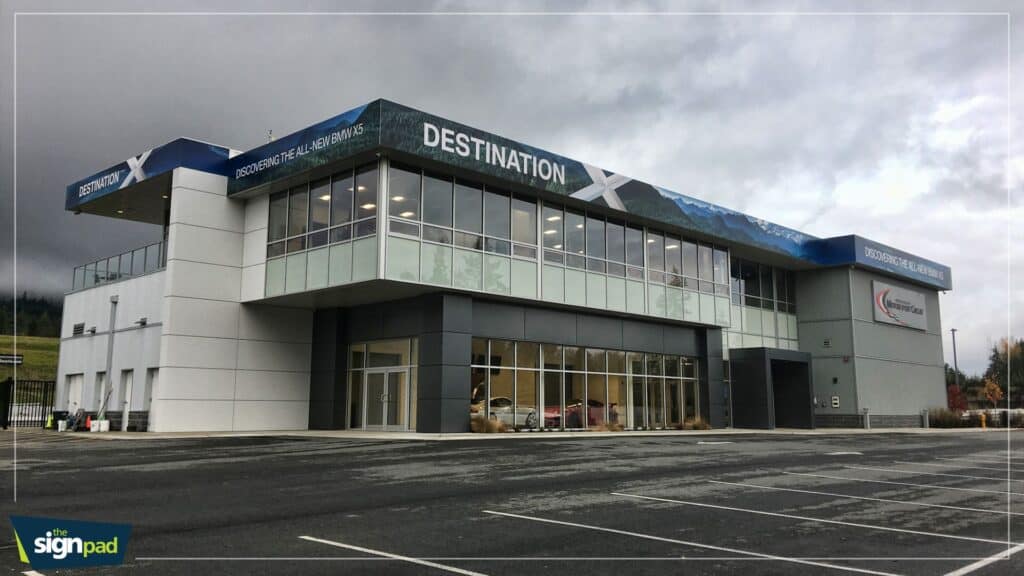 Commercial building with signage and vehicle wraps in Victoria.