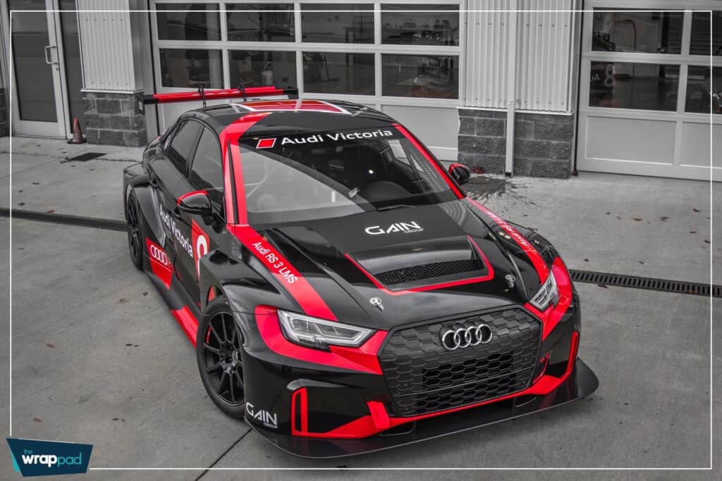Custom Audi race car with Victoria branding and vibrant red accents.