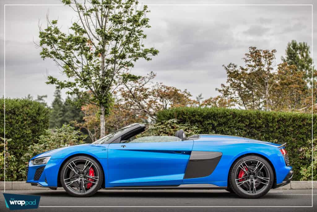 Luxury blue convertible sports car with sleek design and black accents.