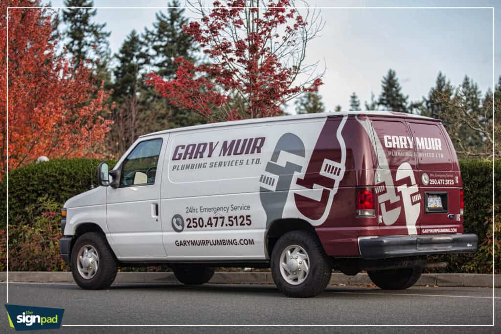 Plumbing service van with custom signage in Victoria.