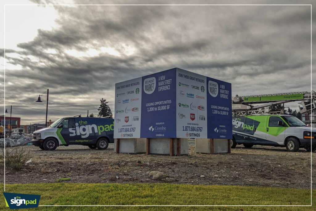 Sign Pad vehicle with custom signs and vehicle wraps in Victoria under cloudy sky.