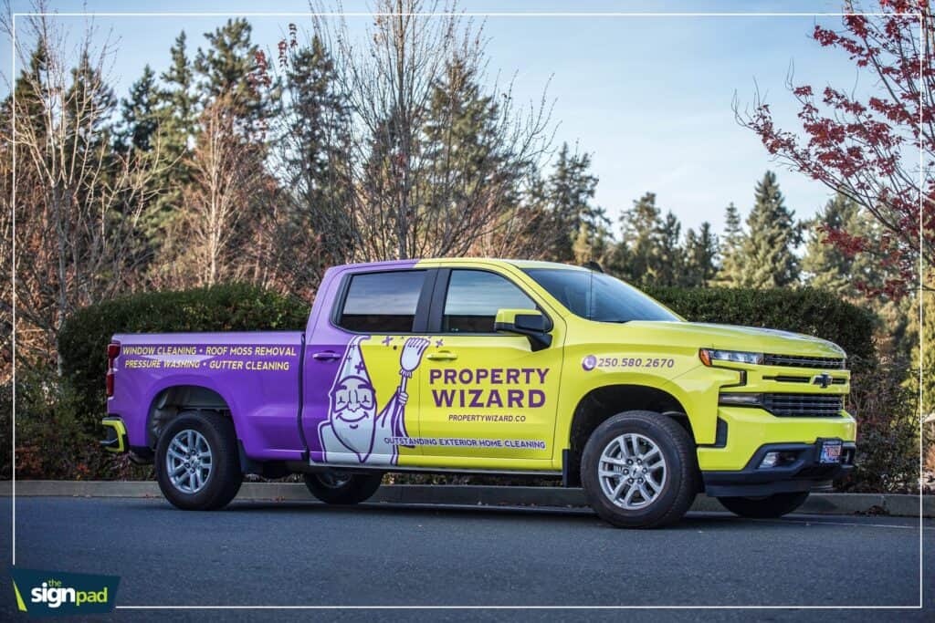 Custom vehicle wrap for Property Wizard with vibrant yellow and purple design.