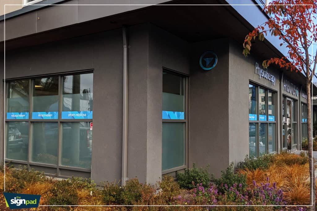 Commercial building exterior with custom signs and vehicle wraps in Victoria.