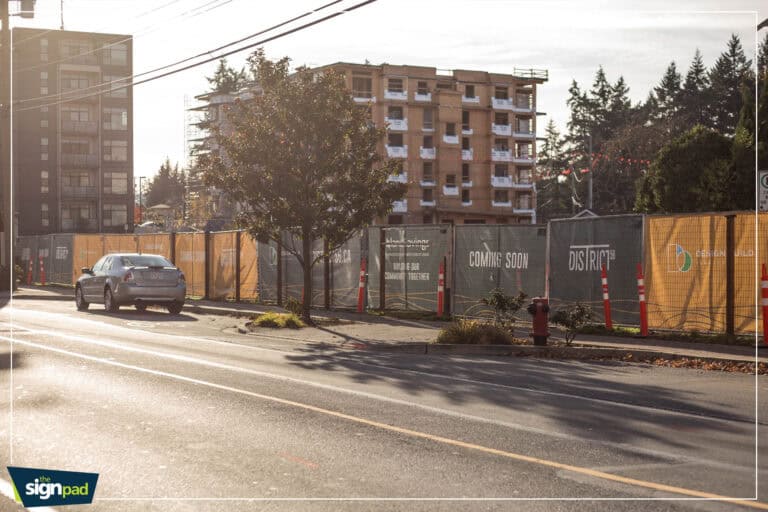 Construction site signage and fencing in Victoria, showcasing upcoming development projects.