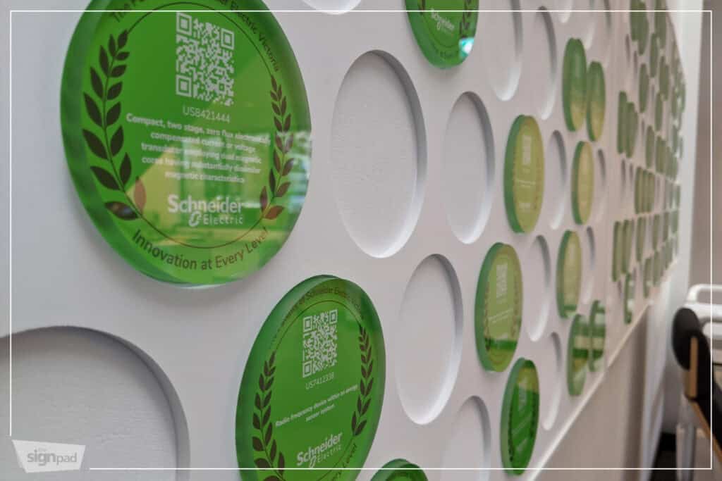 Modern green digital signage wall with QR codes and eco-friendly branding in Victoria.