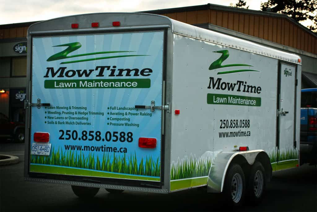 MowTime lawn maintenance trailer with company logo and contact info.