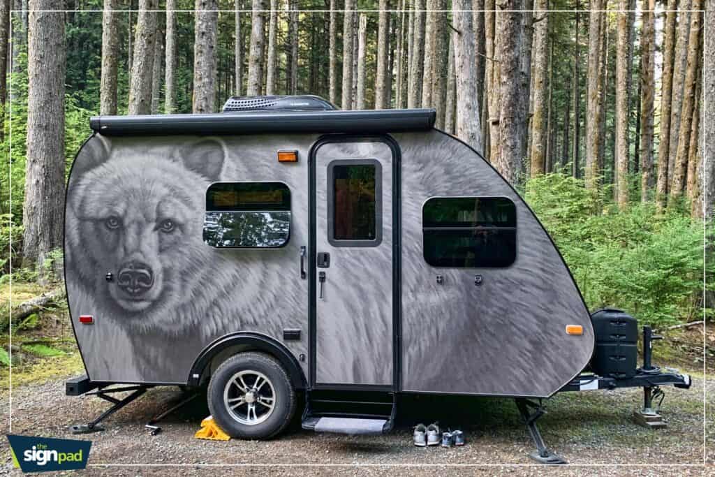 Camping trailer with bear graphic for vehicle wraps and custom signs in Victoria.