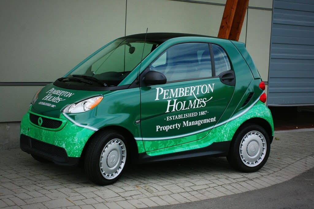 Custom green vehicle wrap for Pemberton Holmes property management company.