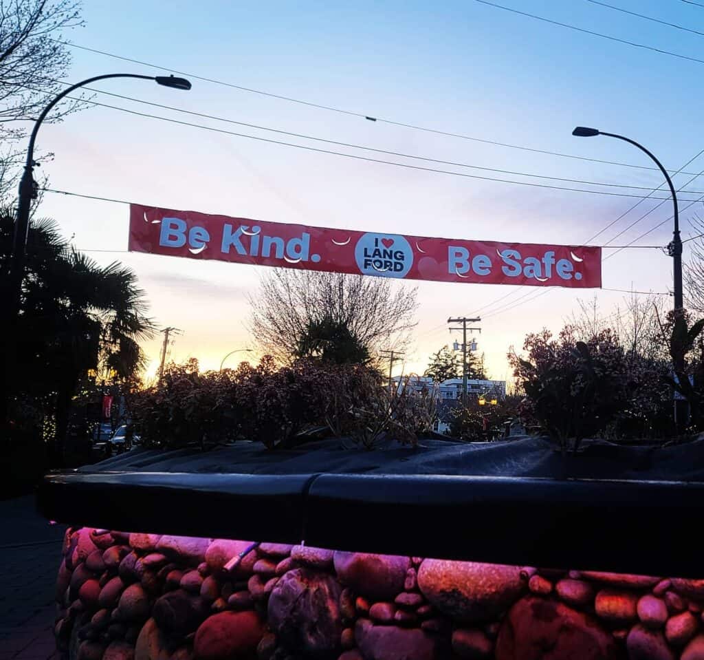 Outdoor banner with "Be Kind" and "Be Safe" messages in Victoria.