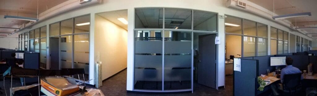 Modern office space with glass partitions and workstations in Victoria.