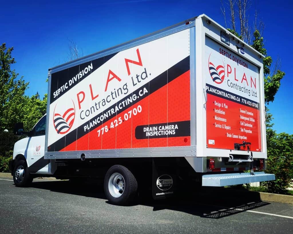 Vehicle wrap for septic division with company branding and contact details.
