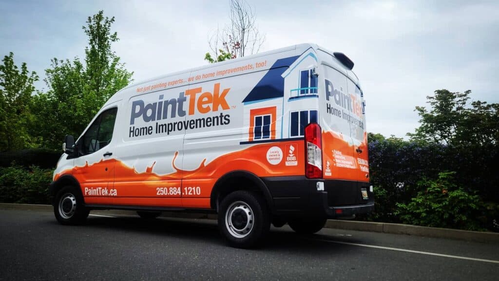 Custom vehicle wrap for PaintTek Home Improvements on a white van with orange and blue graphics.