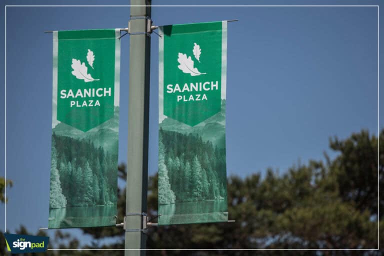 Double-sided Saanich Plaza banners on street pole.