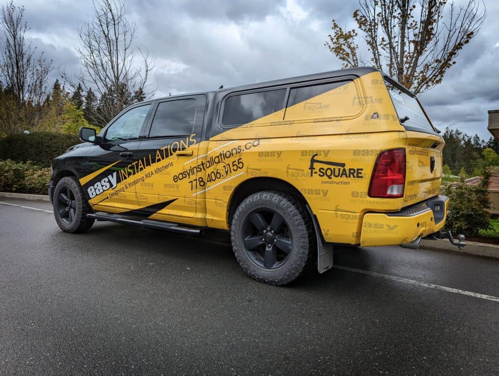 Yellow vehicle wrap with company branding for Easy Installations.