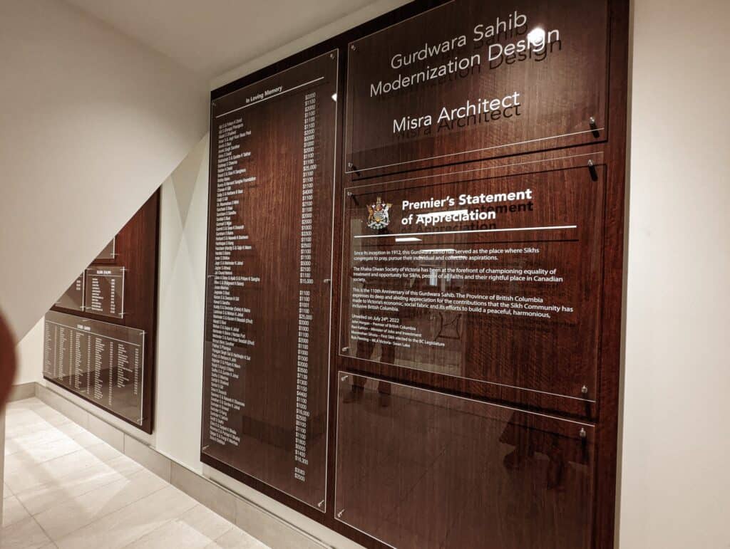 Elegant wooden signboards at Gurdwara Sahib showcasing modern design.