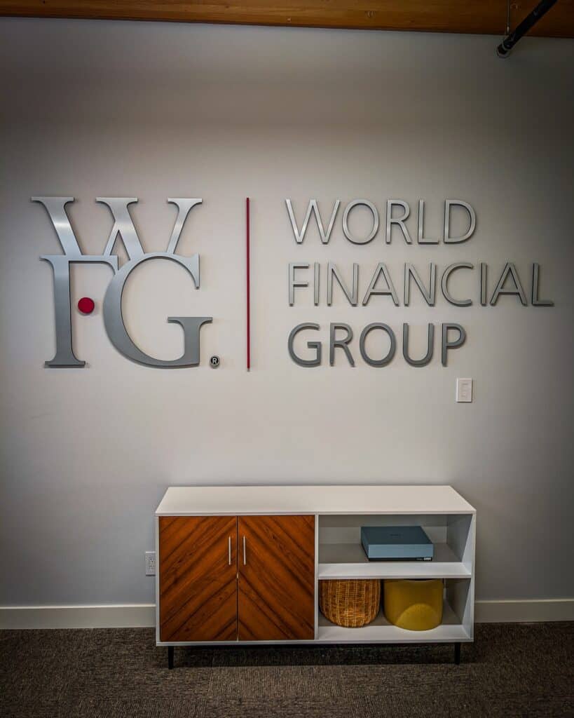 Custom World Financial Group sign on office wall in Victoria.