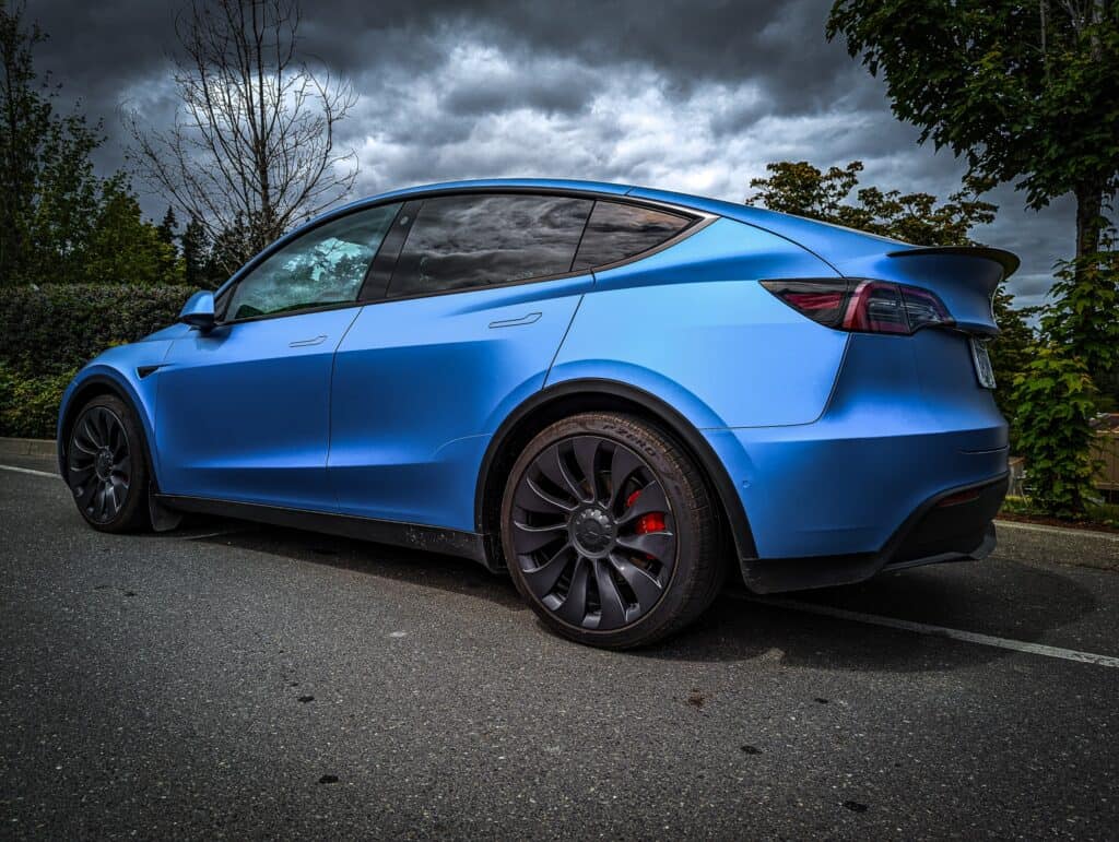 Tesla Model Y electric vehicle with sleek design and black wheels.