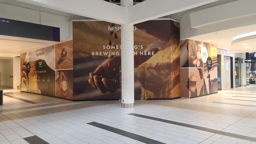Custom sign and vehicle wrap display in Victoria shopping mall.