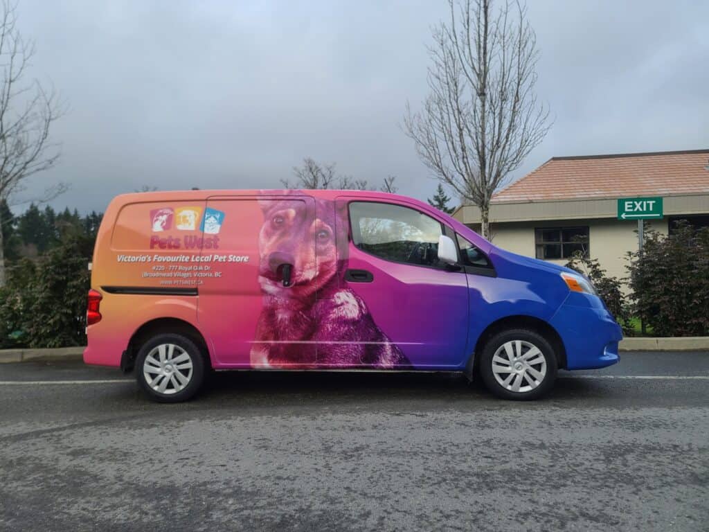 Pet Rescue Sign Van with colorful dog graphic and logo.